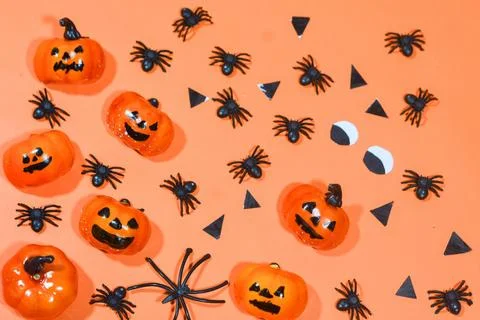 Halloween double border of scattered candy and decor. Flat lay over an oran.. Stock Photos