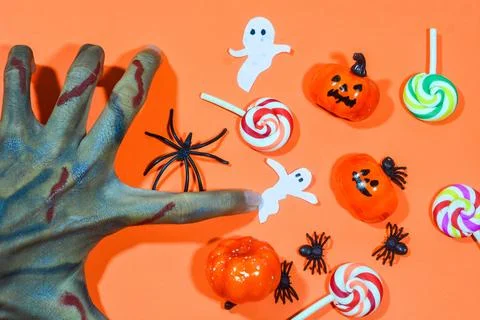 Halloween double border of scattered candy and decor. Flat lay over an oran.. Stock Photos