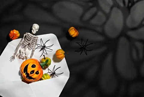 Halloween envelope with skeleton, pumpkins ,spiders and giant web shadow fo.. Stock Photos