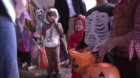 Halloween families and kids trick or treating exterior afternoon Stock Footage