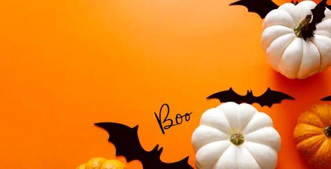 Halloween flat lay composition of black paper bats and pumpkins on orange Stock Photos