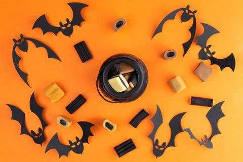 Halloween flat lay composition with candies, bats  and In the center is a sma Stock Photos