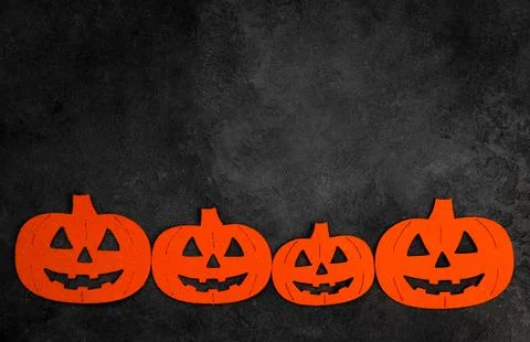 Halloween flat lay with felt pumpinks in black concrete background.Banner wit Stock Photos