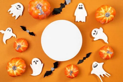 Halloween frame composition with blank white circle mockup on orange background Stock Photos