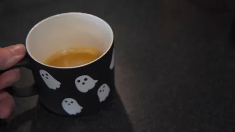 Halloween Ghost Mug with Coffee Placed on Table Stock Footage 346858214