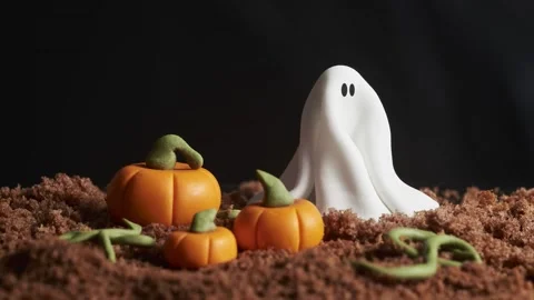 Halloween, ghost in a pumpkin field moves to the right and leaves. Stop motion Stock Footage 137922047