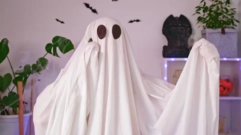 The Halloween Ghost uses a mobile phone for calls, congratulations, intimidation Stock Footage 218613652