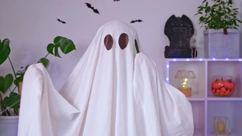 The Halloween Ghost uses a mobile phone for calls, congratulations, intimidation Stock Footage 219633771
