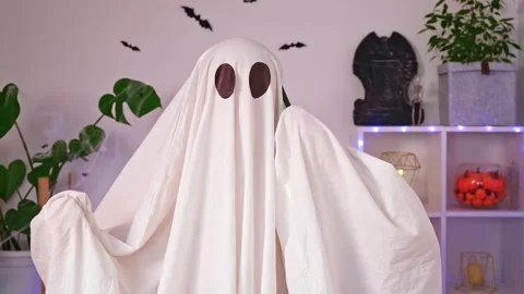 The Halloween Ghost uses a mobile phone for calls, congratulations, intimidation Stock Footage 219966124