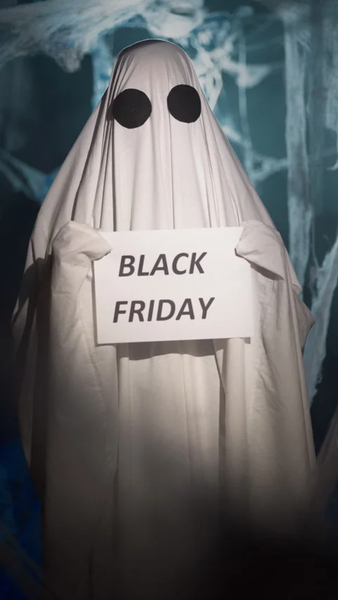 Halloween ghost in white sheet in dark corridor with spider web holding paper Stock Footage 313735205