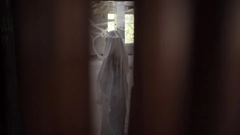 Halloween ghost in white sheet standing in ruined building among cobwebs Stock Footage 311927456