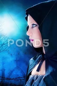 Halloween girl with graveyard in background. Stock Photos