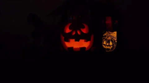 Halloween glowing pumpkins with black background. Orange glow light inside of Stock Footage 142242740