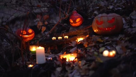 Halloween Holiday Composition. White burning candles, carved pumpkin heads  Stock Footage 139201413