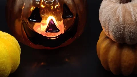 Halloween holiday decor candlestick and pumpkins black background Stock Footage 319690680