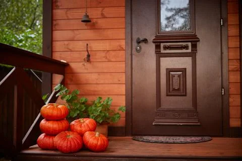 Halloween home decor. Stack pumpkins Near the door of the house. Autumn harvest Foto stock