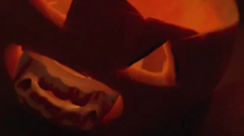Halloween Jack O' Lantern with bloody vampire teeth in mouth, close up shot Stock Footage