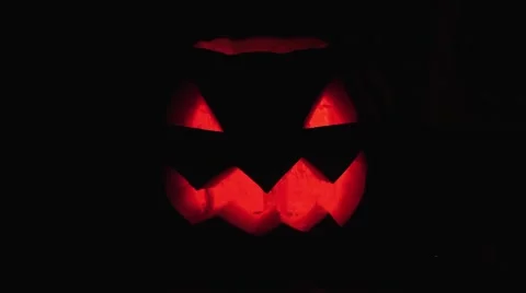 Halloween Jack o lantern with burning candle floats in dark space Stock Footage 68177018