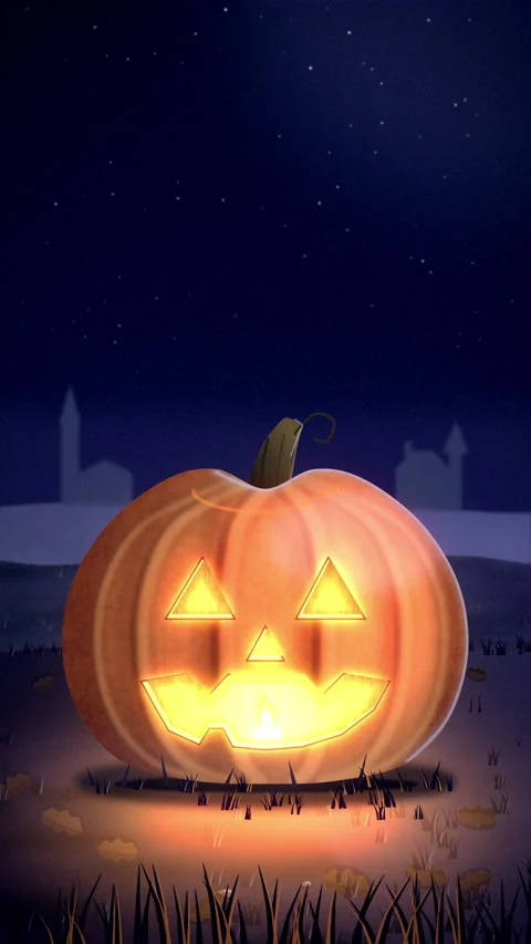 Halloween Jack-o'-Lantern Close-Up Glowing on the Grass at Night Seamless Loop Video stock 347645119