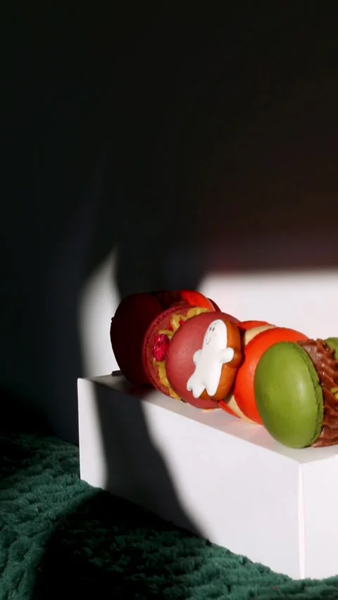 Halloween macarons with ghost design in dramatic window light and shadows. .. Stock Footage 343530138