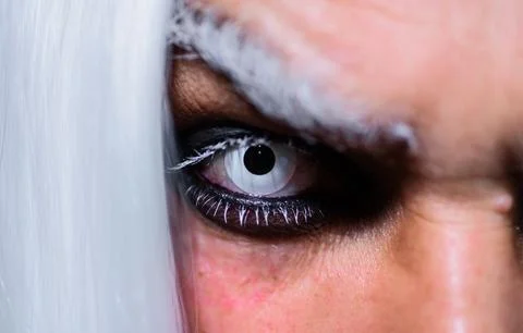 Halloween makeup. Devil, Vampire or Monster Eye Lens. Closeup of man eyes. Ho 스톡 사진