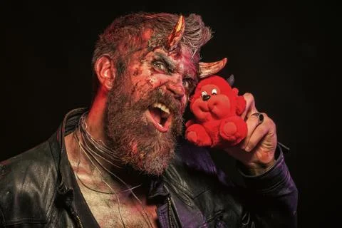 Halloween man roar with red devil toy on black background Stock Photos