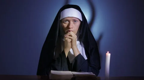 Halloween. nun prays. shadows in the form of devil. exorcism Stock Footage