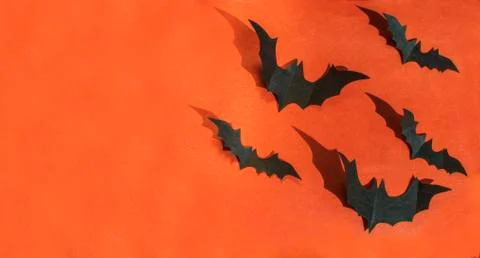 Halloween paper decorations on orange background. Halloween concept. Flat lay Stock Photos