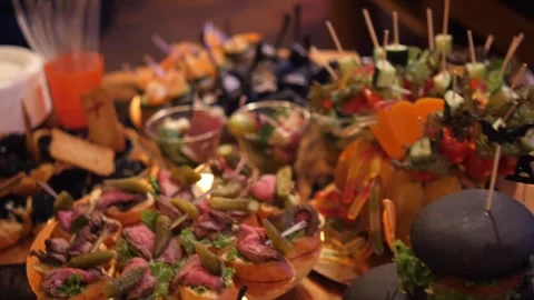Halloween party catering buffet table with various creative spooky appetizers Stock Footage 336794312