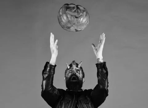 Halloween party concept. Devil or monster with October decorations. Stock Photos