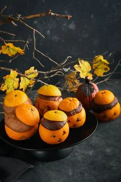 Halloween party jack-o-lantern chocolate orange cakes against the background  Stock Photos