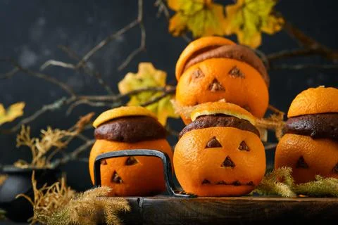 Halloween party jack-o-lantern chocolate orange cakes against the background  Stock Photos