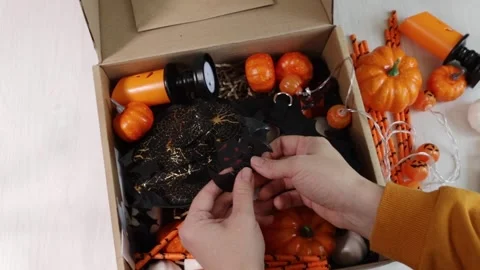Halloween party objects, female hands take out halloween decorations from t.. Stock Footage 248344923