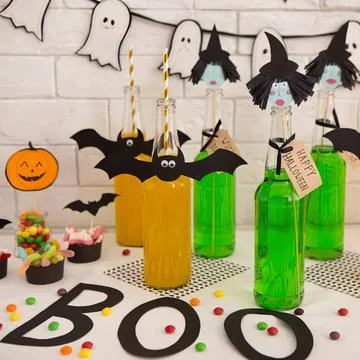 Halloween party table with bats, ghosts, and decorations Stock Photos