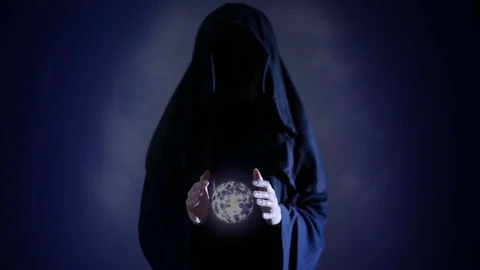Halloween. Powerful witch or wizard with fireball in hands. Ball from fire burns Stock Footage