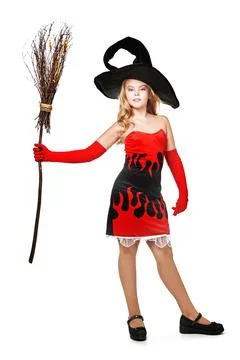 Halloween. Pretty blonde girl child in a witch costume poses with a broom on  Stock Photos