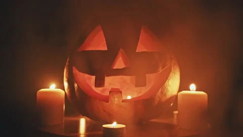 Halloween pumpkin with burning candles and thick smoke around it Stock Footage 140868053