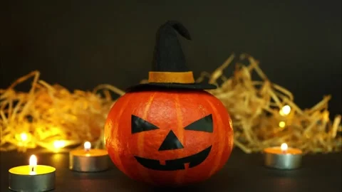 Halloween pumpkin changing various face expressions near candles. Stop motion Stock Footage 253821302