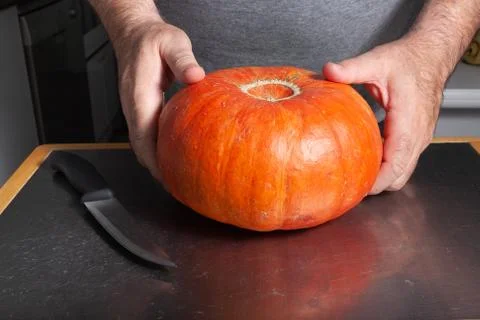 Halloween pumpkin cutting process, process of making Jack-o-lantern. Stock Photos