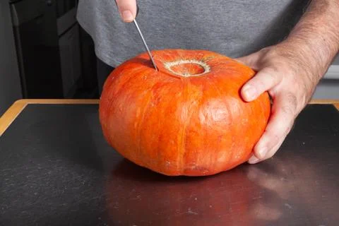 Halloween pumpkin cutting process, process of making Jack-o-lantern. Stock Photos