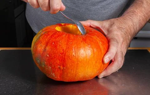Halloween pumpkin cutting process, process of making Jack-o-lantern. Stock Photos