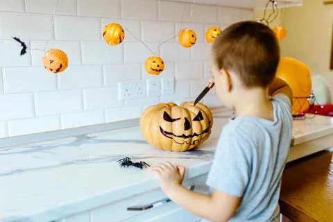 Halloween pumpkin cutting process, process of making Jack-o-lantern. Boy hands Stock Photos