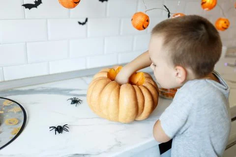 Halloween pumpkin cutting process, process of making Jack-o-lantern. Boy hands Stock Photos