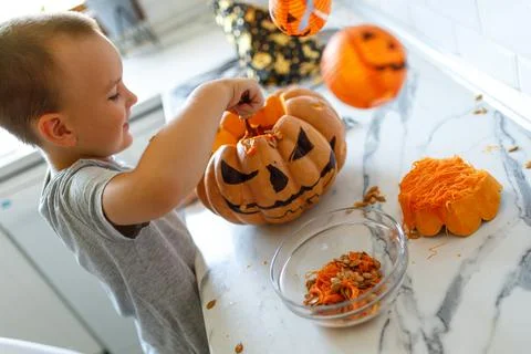 Halloween pumpkin cutting process, process of making Jack-o-lantern. Boy hands Stock Photos