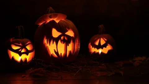 Halloween Pumpkin On Dark Background With Lights On Top Stock Footage