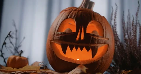 Halloween pumpkin face with candles in it stands in dark windy forest at night Stock Footage 165407853