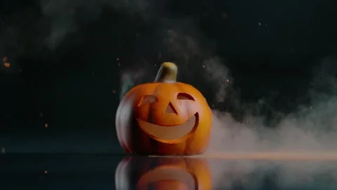Halloween pumpkin on fire glowing inside in the dark. Scary Pumpkin with smoke a Stock Footage 252270470