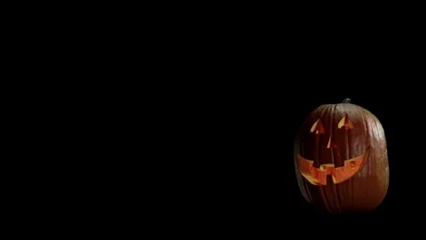 Halloween pumpkin glowing inside in the dark. Scary Pumpkin with smoke around Stock Footage 272460973