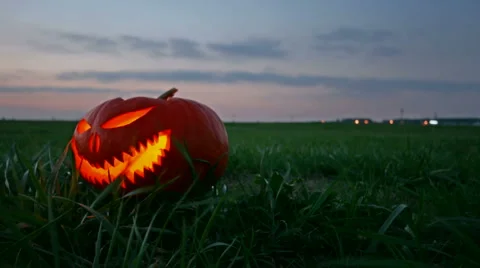 Halloween pumpkin glowing in the night motorized time lapse Stock Footage