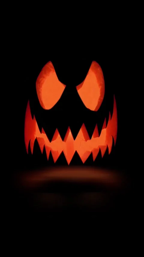 Halloween Pumpkin glows on black background. Traditional symbol. Jack-O-Lantern Stock Footage 288450338